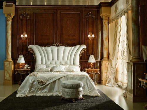 Master bedroom with luxury, classic Italian, Baroque furniture pieces, including large white bed