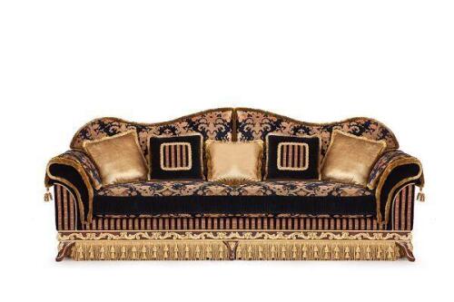 luxury black and gold camelback sofa with decorative wood trim and tasseled skirt from Nino Madia