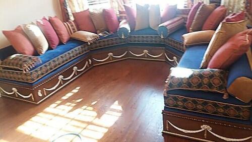 custom window seat sofa with decorative paneling and royal blue cushions by Nino Madia