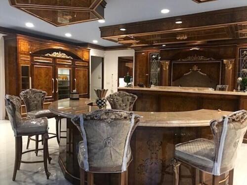 curved custom kitchen island with luxury barstools from Nino Madia