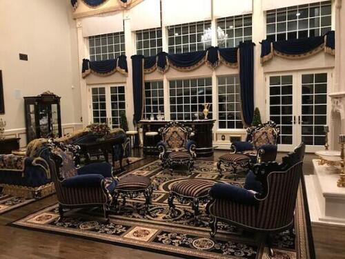 Matching luxury living room set with traditional italian armchairs and footstools. Furniture features carved woodwork and brocade and striped cushions. Custom bar, display cabinets, console table, sofa, and drapes in matching fabrics and dark wood from Ni
