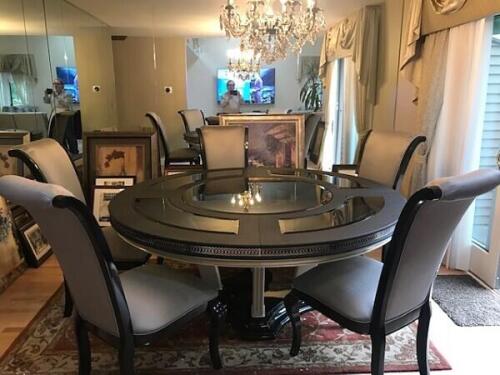 modern black round dining room table that seats 5 with glass inserts and gray upholstered dining chairs from Nino Madia