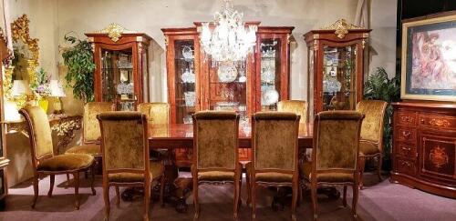 Luxury dining room set that includes a glossy wood table with carved pedestals and 10 chairs in wood and gold fabric. Matching large 3 piece china cabinet set and wood buffet with decorative inlay. Floor samples for sale.