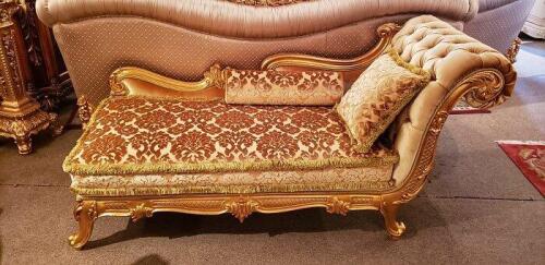 peach colored chaise lounge with tufted cushion, with carved gilded wood frame.