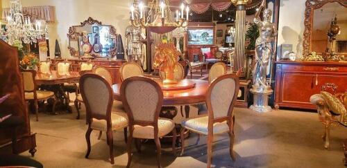 high end traditional round dining room table that seats 8. Dining room chairs have cream brocade patterned cushions. Floor samples for sale.
